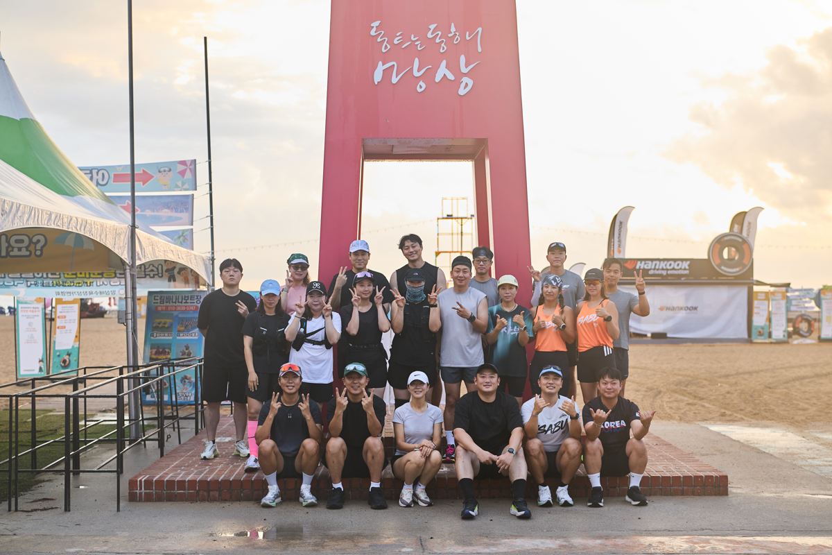 망상 조형물 앞에서 러닝크루 참가자들이 단체 사진을 찍은 모습